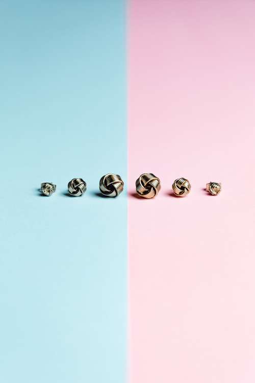 Blue And Pink Background With Earrings In A Line Photo