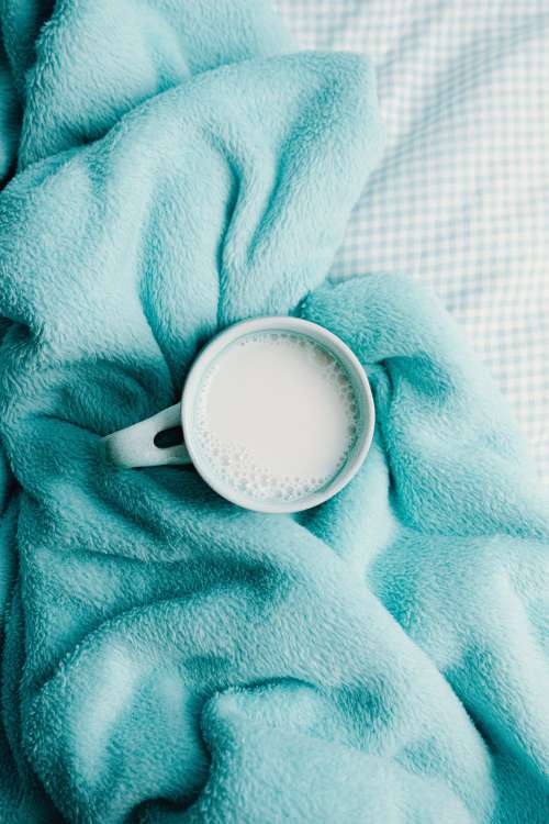 A Mug Surrounded By A Soft Blue Blanket Photo