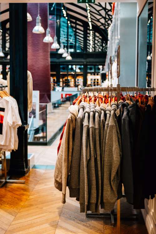 The Inside of A Store With Grey Sweaters Stacked Photo