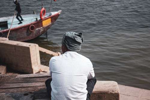Person In Scarf Looking Out At Water Photo