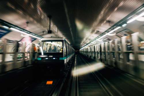 Blurry Photo Of Trains Moving Underground Photo