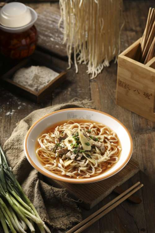 Bowl Of Noodle Soup On Wooden Countertop Photo