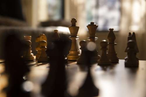 Chess Pieces Set Up On A Wooden Chess Board Photo