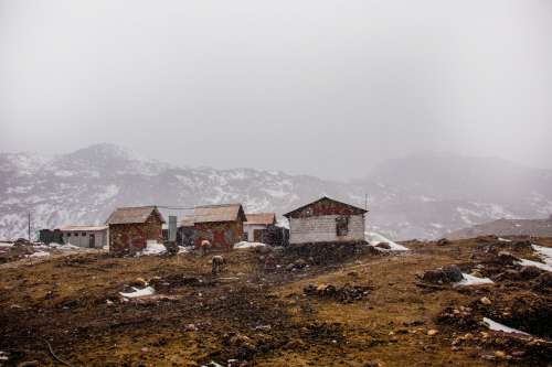 Cabins On A Brown Hill With Soft Falling Snow Photo