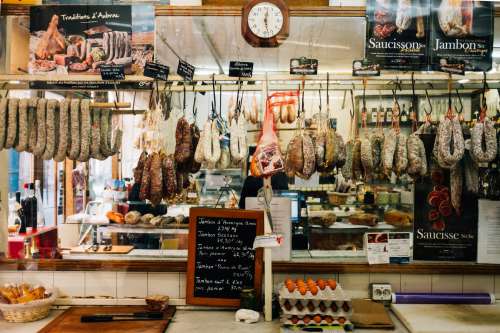 Deli With Cured Meat On Hooks And Eggs On Counter Photo