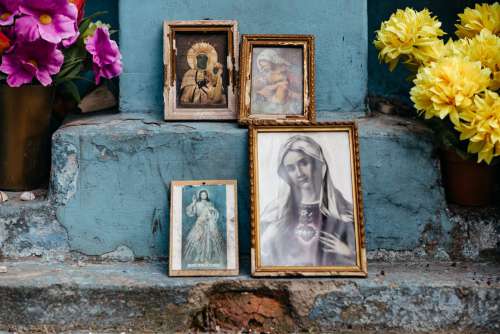Distressed catholic holy pictures placed outside a poor neighbourhood