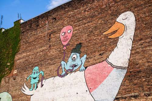 Graffiti of a cartoon duck on a brick wall