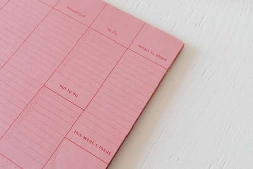 Pink calendar with planner - desk - laptop