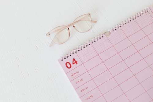 Pink calendar with planner - desk - laptop