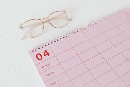 Pink calendar with planner - desk - laptop