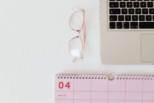 Pink calendar with planner - desk - laptop