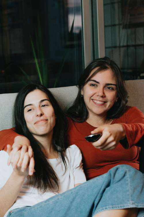 Two Women Sit Together In Their Living Room Photo