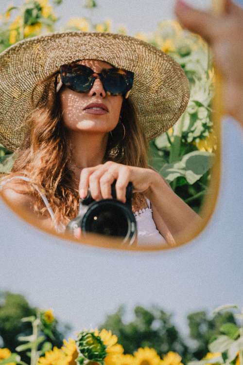 Woman Takes A Mirror Self Portrait Among Sunflowers Photo