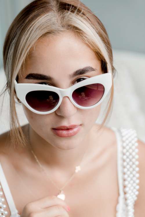 Woman Peeking Over Her Sunglasses Photo