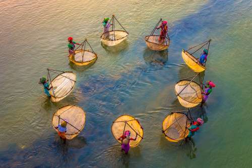 Aerial Photo Of People Stands In A Circle In Water Photo