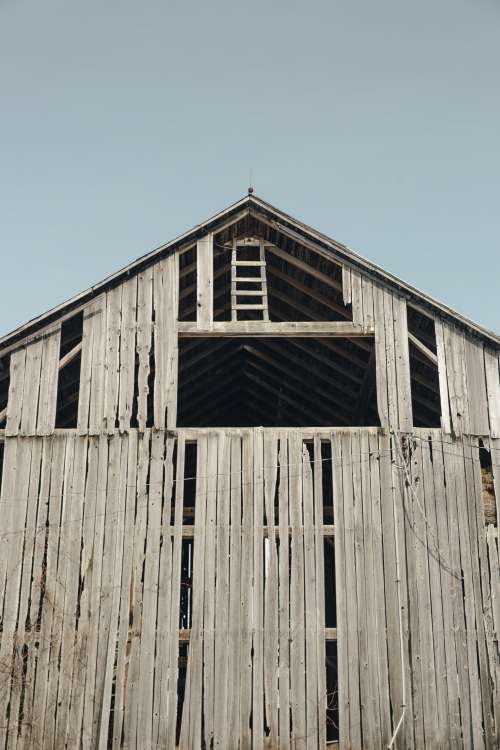 Worn Wooden Barn Against A Clear Blue Sky Photo
