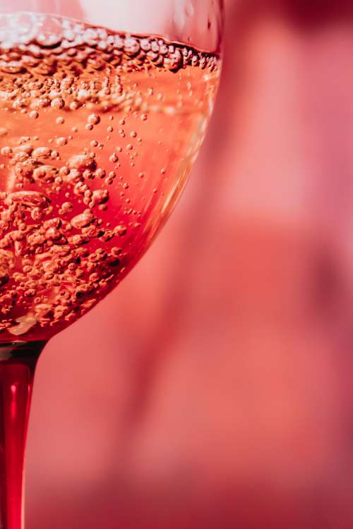Close Up Of Bubbles In A Pink Glass Photo