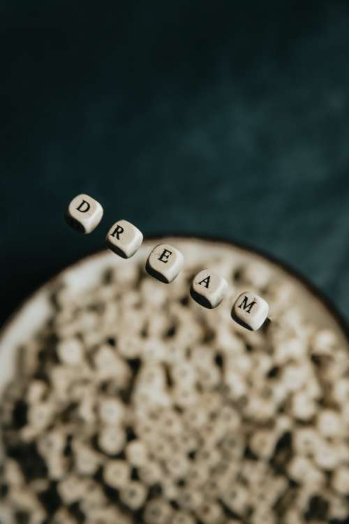 Wooden Beads Float And Spell Out Dream Photo