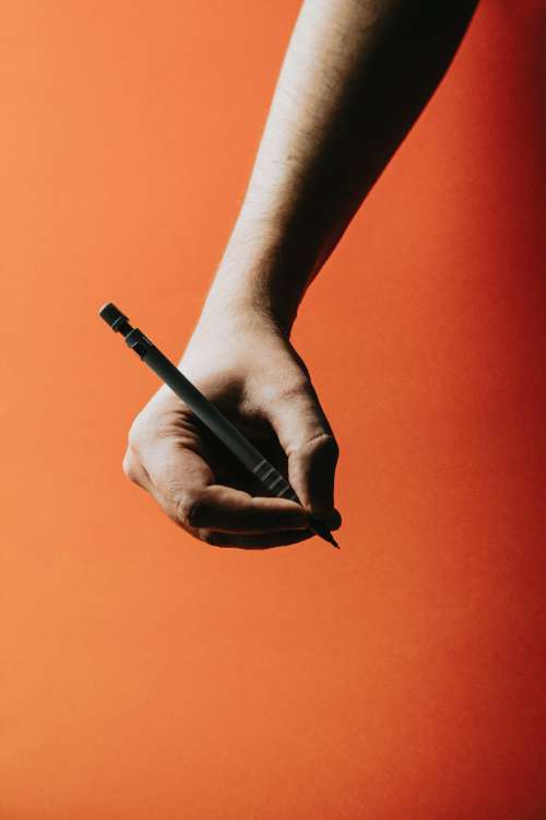 Photo Of A Hand Holding A Pen Photo