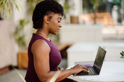 Profile Of A Woman Working On Her Laptop Outdoors Photo