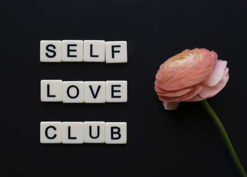 Tiles Read Self Love Club Next To A Pink Flower Photo
