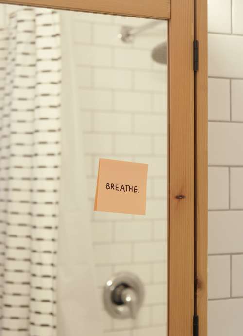 Pink Note Reads Breath On A Bathroom Mirror Photo