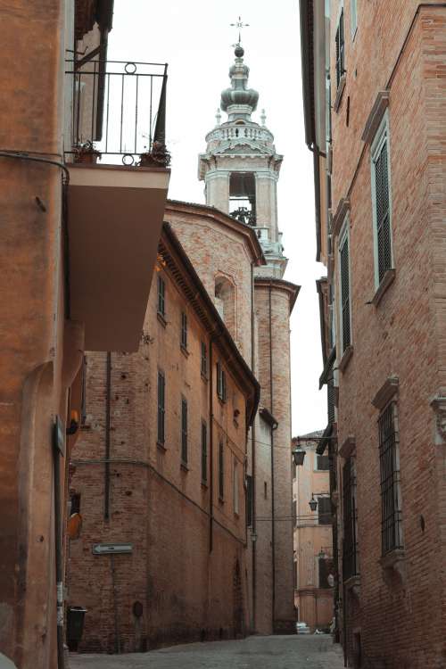 Tall Brick Buildings With A Bell Tower At The Top Photo
