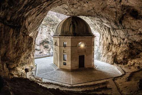 Building In A Cave With A Stone Walkway Photo