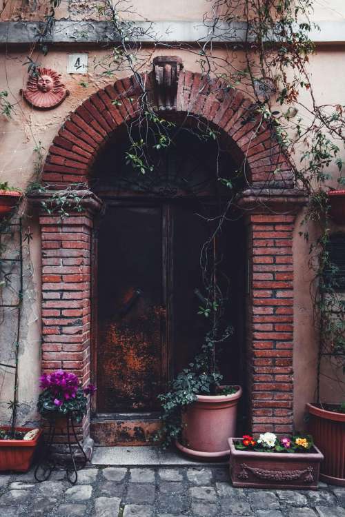 Brick Archway With Plants And Flower Boxes Photo