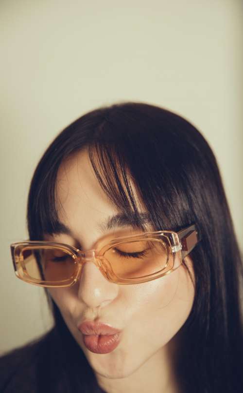 Woman Close Up On Orange Tinted Sunglasses Photo