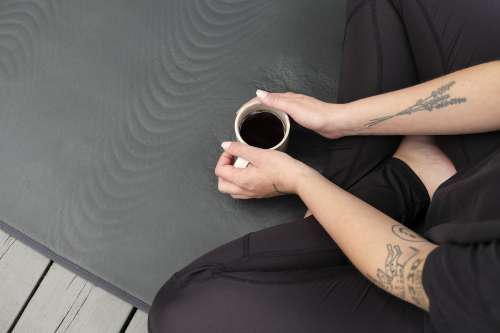 Person Sits Cupping A Mug With Both Hands Photo