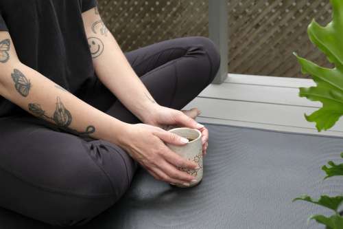 Person In Athletic Wear With A Mug With Both Hands Photo