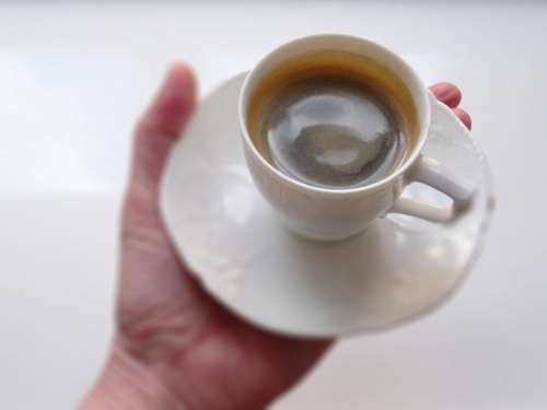 Cup of espresso in a hand