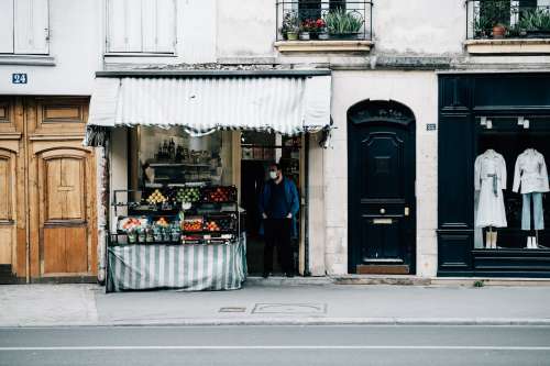 Street With A Fruit Stand And A Person In A Facemask Photo
