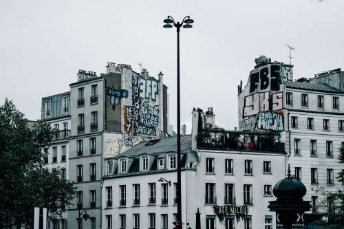White Buildings With Graffiti Covering The Sides Photo