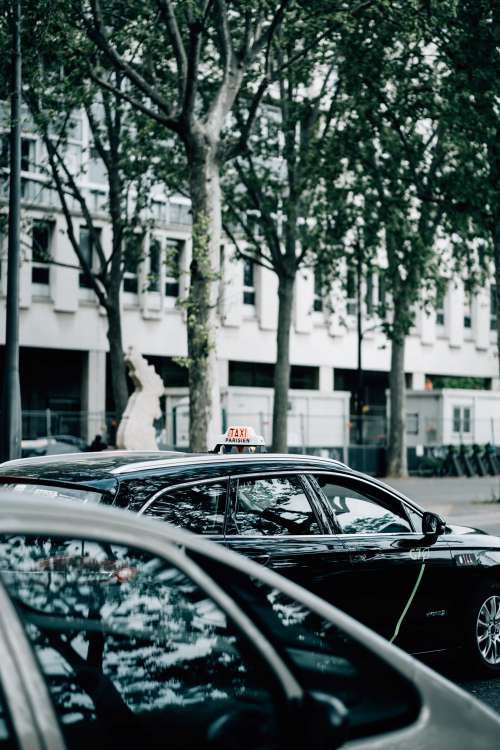 Black Car With A Taxi Sign On Its Roof Photo