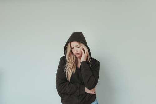 Blond Woman In Black Sweater Closes Her Eyes Photo