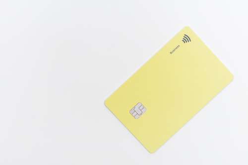Flatlay Of A Yellow Plastic Card With A Tap Chip In It Photo