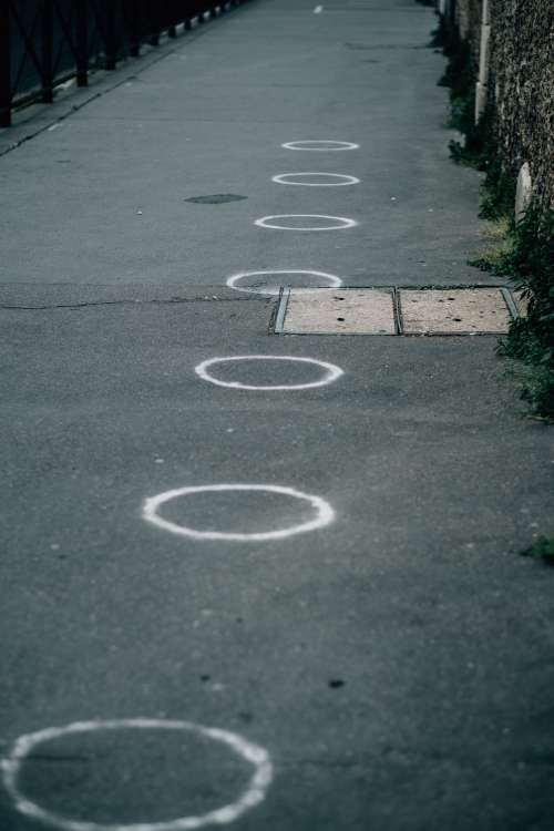 Paved Sidewalk With White Painted Circles Photo