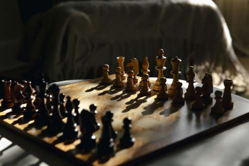 Chess Board Bathed In Light Creating Shadows Photo