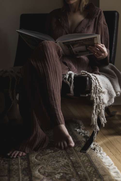 Person Sits Reading A Large Coffee Book Photo