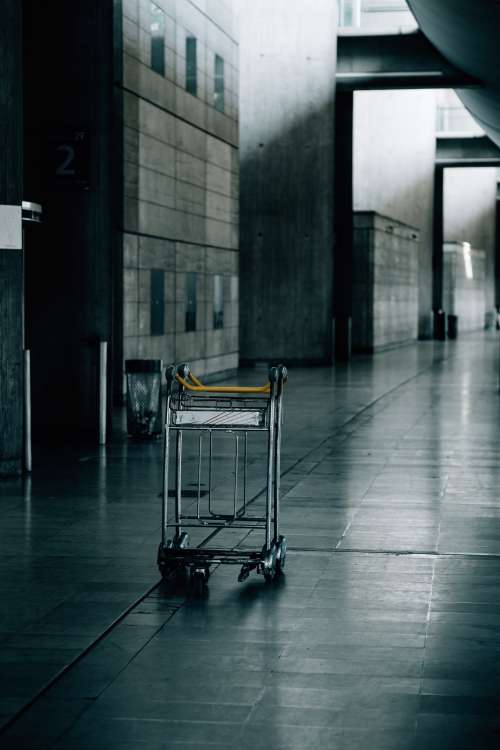 Empty Luggage Cart In An Industrial Hallway Photo