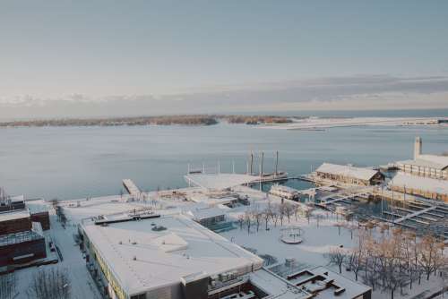 Photo Of Snow Covered Buildings By A Harbour Photo
