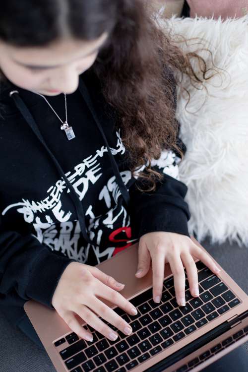Person Typing On A Laptop Viewed From Overhead Photo