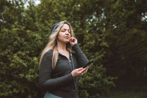 Woman Listening To Music Closes Her Eyes In Enjoyment Photo