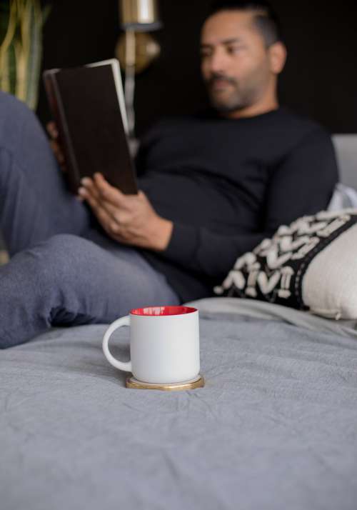 White Mug Coaster Sits On A Grey Blanket Photo