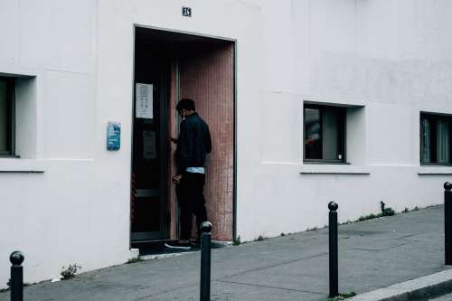 Person Waiting To Enter At A Building Entrance Photo