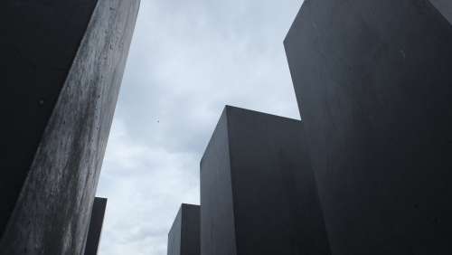Tall Cement Blocks Against A Cloudy Sky Photo