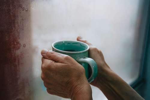 Hands Holding A Green Mug Photo