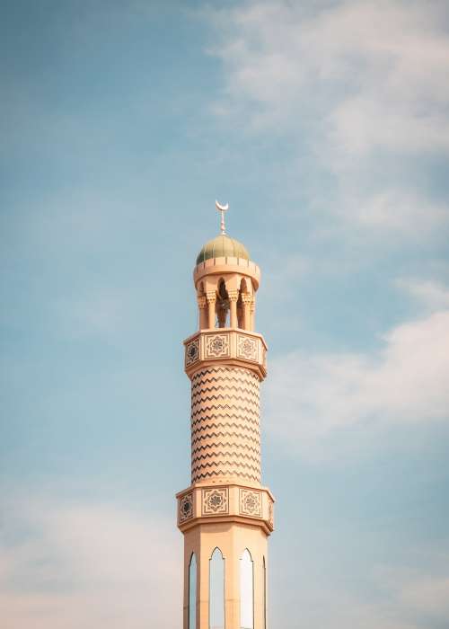 Tall Thin Tower With A Round Roof Against A Blue Sky Photo